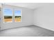 Sun-filled bedroom featuring neutral carpet, white walls and two large windows at 213 Groveton Ct, Euharlee, GA 30145