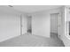 Carpeted bedroom featuring white walls, natural light from a window, and closet at 213 Groveton Ct, Euharlee, GA 30145