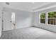 The spacious bedroom features carpeting, neutral walls, and two windows at 213 Groveton Ct, Euharlee, GA 30145