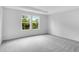 The bright bedroom has neutral walls and carpet, plus two outdoor-facing windows at 213 Groveton Ct, Euharlee, GA 30145