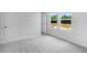 Bright bedroom featuring neutral carpet, white walls, and a natural light from double hung windows at 213 Groveton Ct, Euharlee, GA 30145