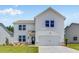 Charming two-story home featuring a modern facade, well-manicured lawn, and attached two-car garage at 213 Groveton Ct, Euharlee, GA 30145