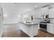An open kitchen featuring stainless steel appliances, granite countertops, and a spacious island at 213 Groveton Ct, Euharlee, GA 30145