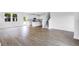 Open concept living room featuring hardwood floors, stairs and a view into the kitchen at 213 Groveton Ct, Euharlee, GA 30145