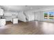 Open concept living room featuring hardwood floors, stairs, kitchen and a door to the outside at 213 Groveton Ct, Euharlee, GA 30145