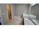 Bathroom view with white vanity, granite countertop, tub, and tiled floors at 3285 Wild Basil Ln, Buford, GA 30519