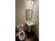 Small bathroom including toilet and vanity with a pedestal sink at 3285 Wild Basil Ln, Buford, GA 30519