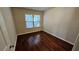 Cozy bedroom with hardwood floors and natural light from the window at 3285 Wild Basil Ln, Buford, GA 30519