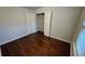 Bedroom with hardwood floors and closet with shelving at 3285 Wild Basil Ln, Buford, GA 30519