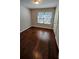 Bedroom with hardwood floors and bright natural light from the window at 3285 Wild Basil Ln, Buford, GA 30519