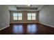 Bedroom features hardwood floors and a tray ceiling at 3285 Wild Basil Ln, Buford, GA 30519