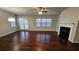 Open concept living room with a cozy fireplace and access to the backyard at 3285 Wild Basil Ln, Buford, GA 30519