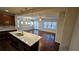 Open floorplan showing the kitchen with large island and the spacious living room with hardwood floors at 3285 Wild Basil Ln, Buford, GA 30519