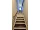 Staircase leading up to the second floor with a wooden handrail at 3285 Wild Basil Ln, Buford, GA 30519