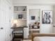 Bright bedroom featuring built-in desk and shelves, and a glimpse of the living area at 75 14Th Ne St # 3830, Atlanta, GA 30309