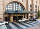 Elegant entrance of Four Seasons Hotel with valet parking, featuring modern architecture and luxury cars at 75 14Th Ne St # 3830, Atlanta, GA 30309