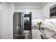 Kitchen showcases stainless steel refrigerator, sleek white cabinets and marble backsplash at 75 14Th Ne St # 3830, Atlanta, GA 30309