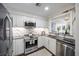 Updated kitchen with white cabinets, stainless steel appliances, granite countertops, and modern finishes at 75 14Th Ne St # 3830, Atlanta, GA 30309
