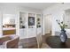 Open living area with a view into the main bedroom, built-in shelving, and modern furnishings at 75 14Th Ne St # 3830, Atlanta, GA 30309