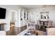 Bright living room with hardwood floors, built-in shelves, and a dining area featuring stylish pendant lighting at 75 14Th Ne St # 3830, Atlanta, GA 30309