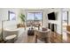 Stylish living room with a curved sofa, balcony access, hardwood floors, and modern decor at 75 14Th Ne St # 3830, Atlanta, GA 30309