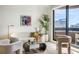 Bright and airy living room with a city view from the balcony, plus comfortable and modern furnishings at 75 14Th Ne St # 3830, Atlanta, GA 30309