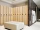 Modern locker room with wooden lockers, soft lighting, and a comfortable bench for a premium experience at 75 14Th Ne St # 3830, Atlanta, GA 30309