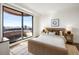 Bedroom with large window and city views, neutral decor, and wood floors at 75 14Th Ne St # 3830, Atlanta, GA 30309