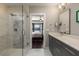 Sleek bathroom featuring a modern vanity, glass shower, and an open view to the main bedroom at 103 Birch St, Decatur, GA 30030