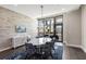 Dining room with an oval marble table, contemporary light fixture, and a brick accent wall at 103 Birch St, Decatur, GA 30030
