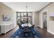 Dining room with light brick accent wall and an elegant light fixture at 103 Birch St, Decatur, GA 30030