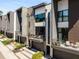 Modern townhome with mixed materials, a balcony, and a gray garage door and walkway at 103 Birch St, Decatur, GA 30030