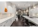 Modern kitchen with quartz countertops, barstool seating, and stainless steel appliances overlooking the living area at 103 Birch St, Decatur, GA 30030