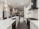 Well-lit kitchen showcasing a quartz island, sleek white cabinetry, and stainless steel appliances at 103 Birch St, Decatur, GA 30030