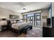 Stylish main bedroom featuring a ceiling fan and a large window with natural light and neighborhood views at 103 Birch St, Decatur, GA 30030
