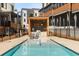 Community pool area with outdoor kitchen, lounge chairs, and well-manicured landscaping at 103 Birch St, Decatur, GA 30030