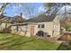 Green backyard with a concrete patio, grill, and chain link fence at 1277 Mcpherson Se Ave, Atlanta, GA 30316