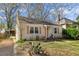 Quaint house with driveway and inviting curb appeal surrounded by lush greenery at 1277 Mcpherson Se Ave, Atlanta, GA 30316