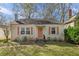 Charming single-story home with a well-manicured lawn and a coral-colored front door at 1277 Mcpherson Se Ave, Atlanta, GA 30316
