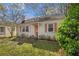 Charming single-story home with a well-manicured lawn, cute shrubs, and a coral-colored front door at 1277 Mcpherson Se Ave, Atlanta, GA 30316