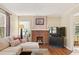 Bright living room with hardwood floors, a brick fireplace, and lots of natural light at 1277 Mcpherson Se Ave, Atlanta, GA 30316