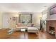 Cozy living room featuring a decorative brick fireplace and plenty of comfortable seating next to a large window at 1277 Mcpherson Se Ave, Atlanta, GA 30316