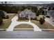 Aerial view of a beautiful home, circular driveway and well maintained landscaping at 912 Fire Thorn Dr, Hampton, GA 30228