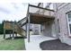 Backyard view of a brick home and patio with a wooden deck above at 912 Fire Thorn Dr, Hampton, GA 30228