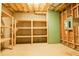Unfinished basement with wooden shelving units at 912 Fire Thorn Dr, Hampton, GA 30228