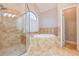 Bathroom featuring a glass shower, soaking tub, and tiled surround at 912 Fire Thorn Dr, Hampton, GA 30228
