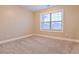 Bedroom featuring a window letting in light and plush carpeting at 912 Fire Thorn Dr, Hampton, GA 30228