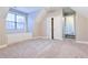 Large bedroom with soft carpet and built-in storage underneath a bright window at 912 Fire Thorn Dr, Hampton, GA 30228