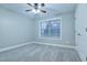 Neutral bedroom features soft carpet, a ceiling fan, and a bright window at 912 Fire Thorn Dr, Hampton, GA 30228