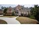 Beautiful two-story brick home featuring a well-manicured lawn and elegant landscaping at 912 Fire Thorn Dr, Hampton, GA 30228